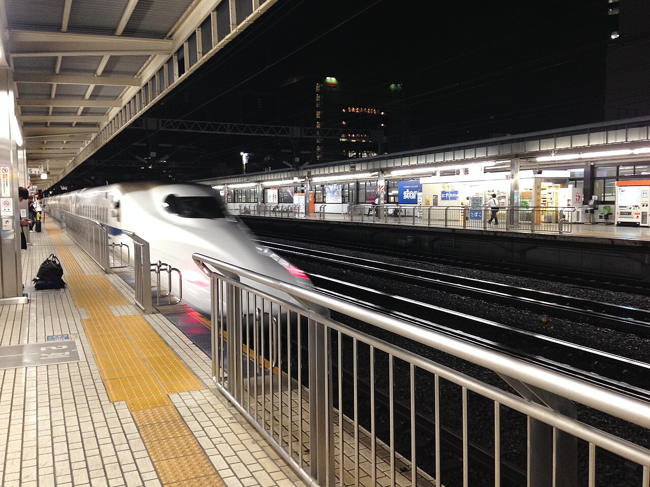 Electric high-speed train arriving at a station at night